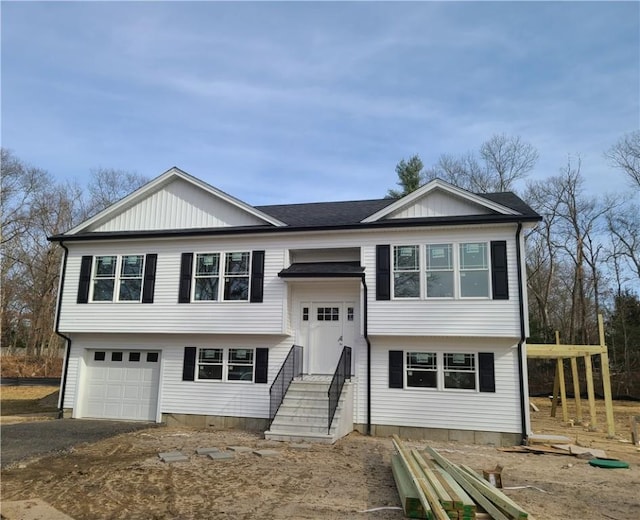 split foyer home featuring a garage and driveway