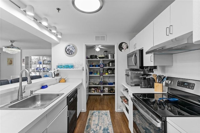 kitchen with visible vents, dark wood finished floors, a sink, appliances with stainless steel finishes, and under cabinet range hood