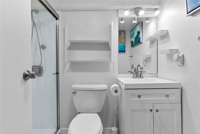 bathroom featuring a shower stall, toilet, and vanity