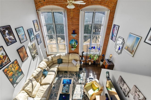 living area featuring plenty of natural light, wood finished floors, and ceiling fan