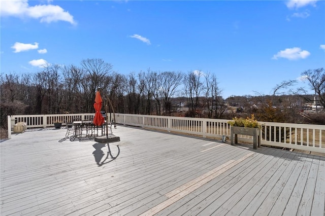 wooden terrace with outdoor dining area