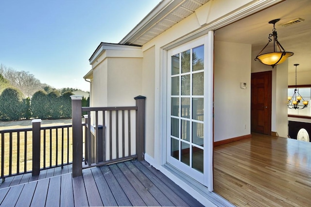 wooden deck featuring visible vents