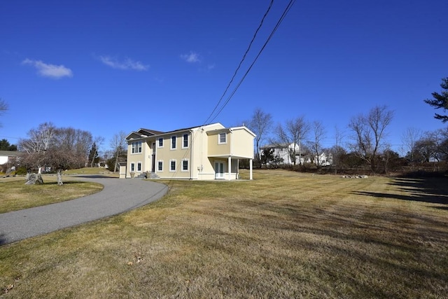 back of house featuring a yard and stucco siding