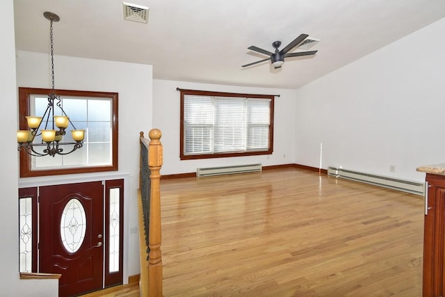 entrance foyer with visible vents, baseboard heating, and light wood-style flooring