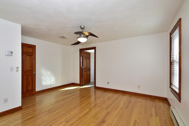 unfurnished room featuring baseboards, visible vents, a baseboard radiator, ceiling fan, and light wood-style floors