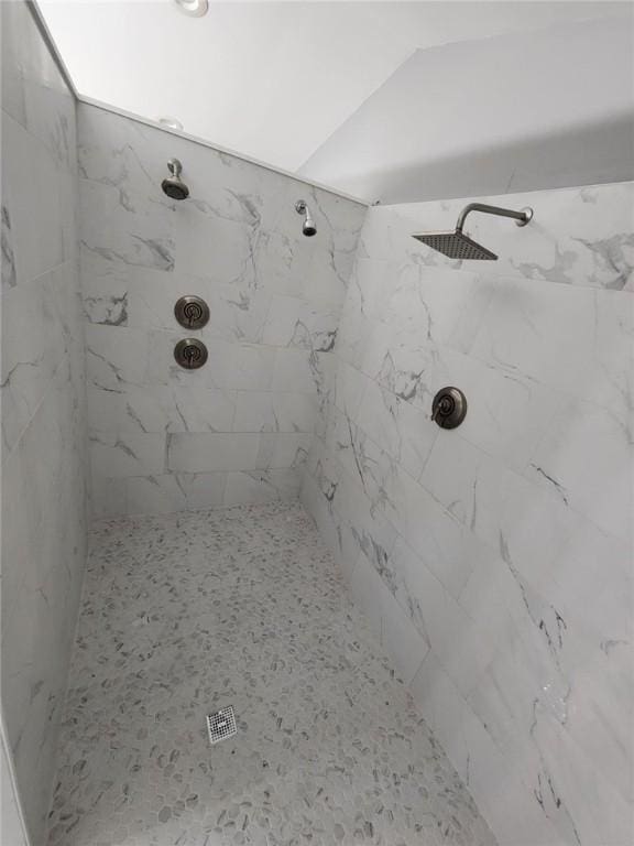 full bath featuring a tile shower