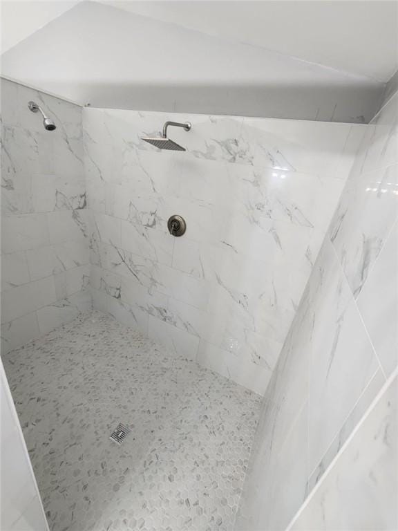 bathroom with tiled shower