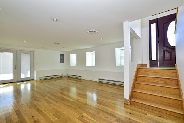 foyer featuring stairs, french doors, light wood-type flooring, and baseboard heating