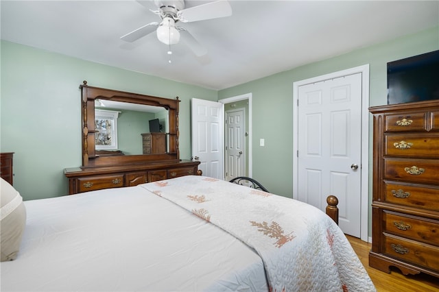 bedroom with a ceiling fan and wood finished floors