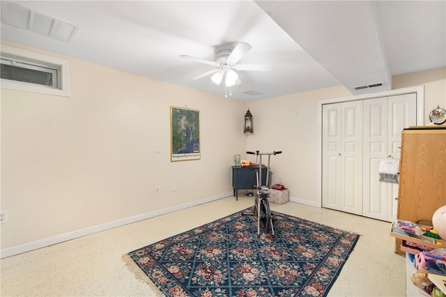 workout room featuring baseboards, visible vents, and ceiling fan