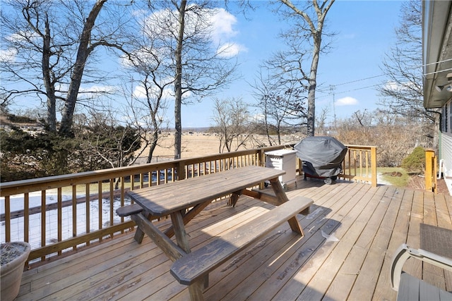 deck with outdoor dining space and area for grilling