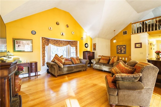 living room featuring visible vents, baseboards, baseboard heating, light wood-style flooring, and high vaulted ceiling