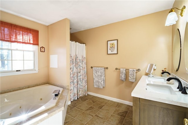 full bath with double vanity, baseboards, a whirlpool tub, and a sink