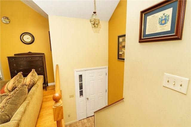 hall with baseboards and light wood-style floors