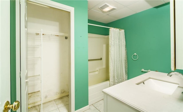 bathroom with visible vents, a drop ceiling, a sink, shower / tub combo, and tile patterned floors