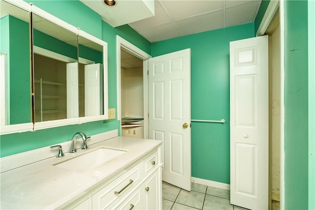 bathroom featuring tile patterned flooring, vanity, and baseboards