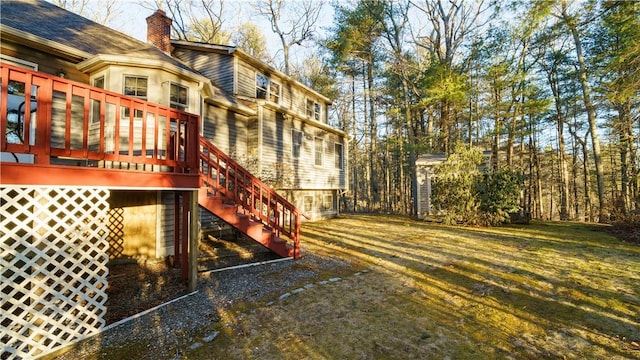 exterior space featuring a yard, a deck, and stairs