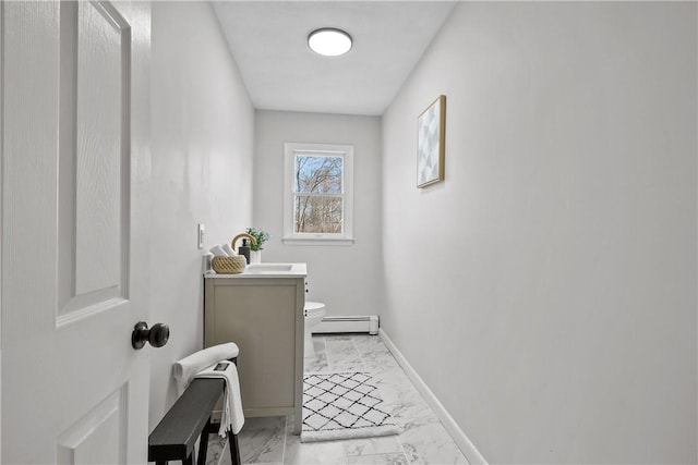 bathroom with vanity, baseboards, a baseboard heating unit, toilet, and marble finish floor