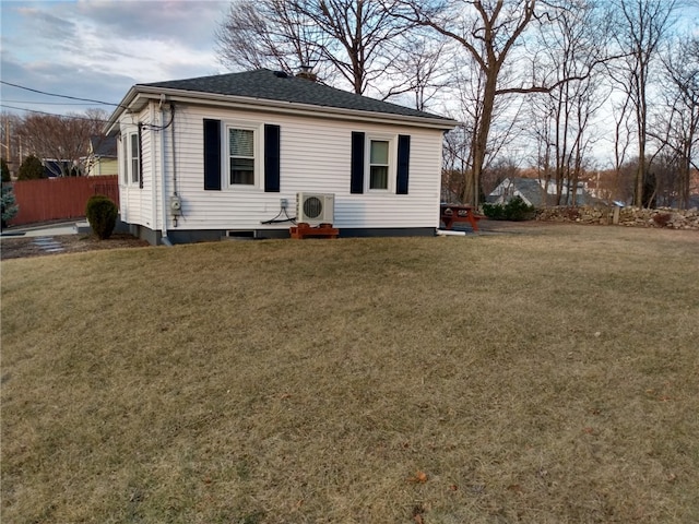 view of front of house featuring a front lawn, ac unit, and fence