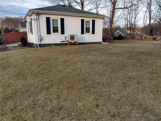 view of front of home with ac unit, a front yard, and fence