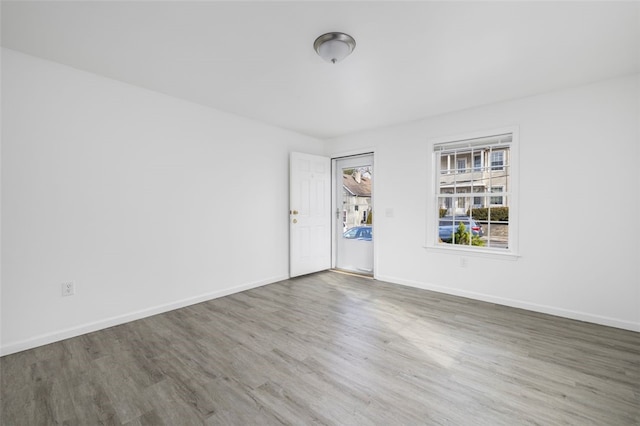 empty room featuring baseboards and wood finished floors