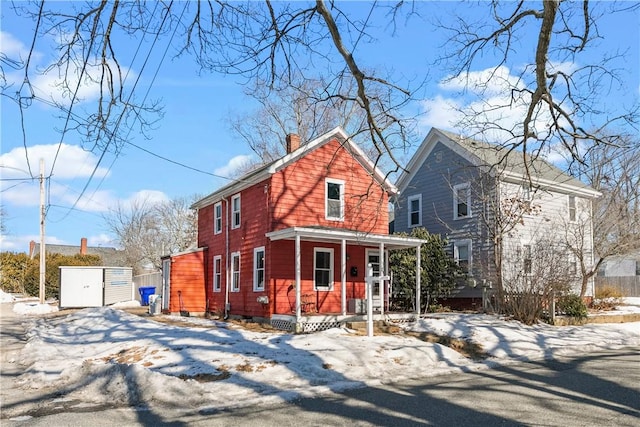 view of front of property featuring covered porch and a chimney