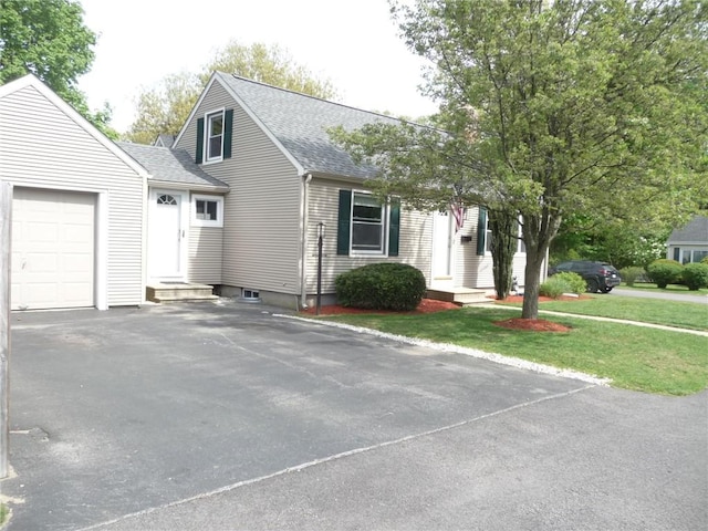 22 Kendall Ln, Warwick, RI 02888 - view of front of home featuring a garage, a front lawn, roof with shingles, and driveway