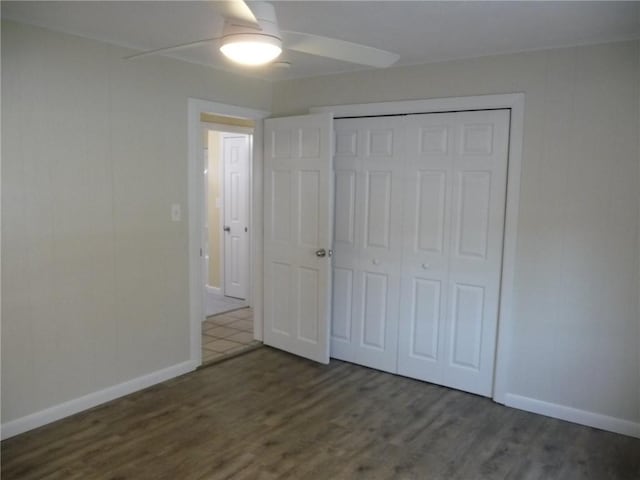22 Kendall Ln, Warwick, RI 02888 - unfurnished bedroom with baseboards, a closet, and wood finished floors