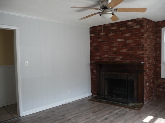 22 Kendall Ln, Warwick, RI 02888 - unfurnished living room featuring a brick fireplace, a ceiling fan, ornamental molding, and wood finished floors