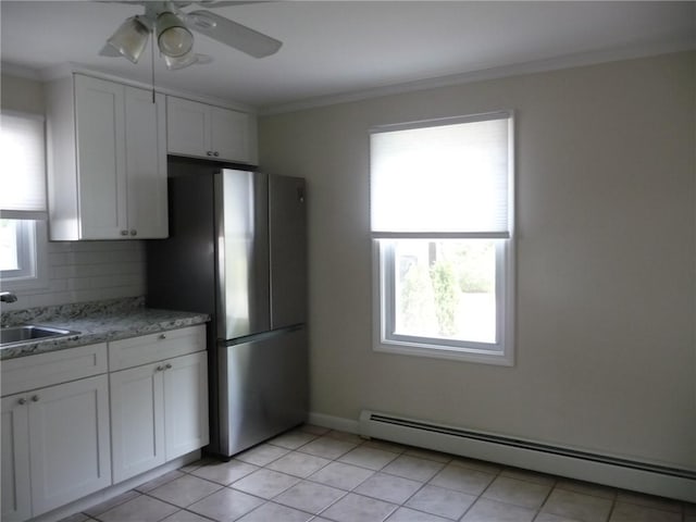 22 Kendall Ln, Warwick, RI 02888 - kitchen featuring a ceiling fan, a sink, freestanding refrigerator, a baseboard heating unit, and white cabinetry