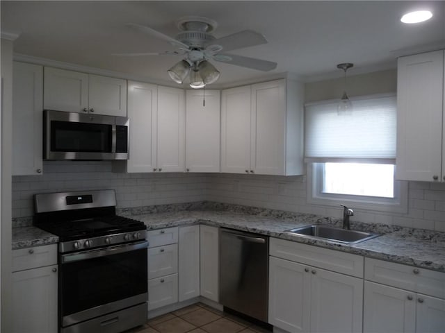 22 Kendall Ln, Warwick, RI 02888 - kitchen with a sink, white cabinets, tasteful backsplash, a ceiling fan, and stainless steel appliances
