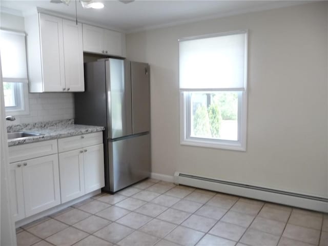22 Kendall Ln, Warwick, RI 02888 - kitchen featuring freestanding refrigerator, white cabinetry, a baseboard heating unit, tasteful backsplash, and a sink