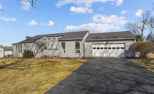 view of front facade featuring aphalt driveway, an attached garage, and a front lawn