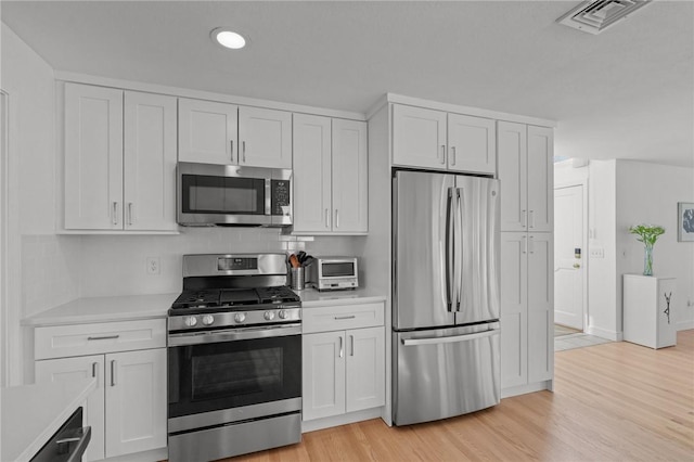 kitchen with light countertops, visible vents, and appliances with stainless steel finishes