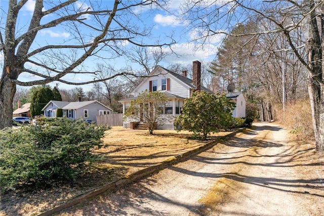 exterior space with fence and a chimney