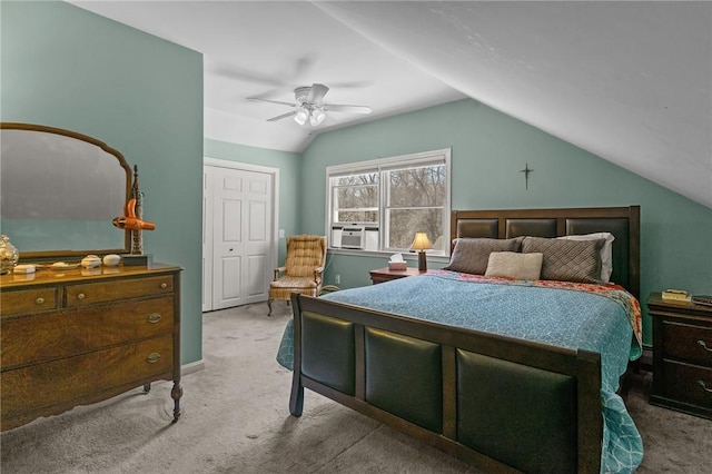 carpeted bedroom with a ceiling fan and vaulted ceiling