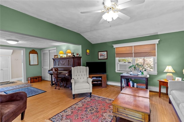 living room featuring a baseboard radiator, baseboards, lofted ceiling, and wood finished floors