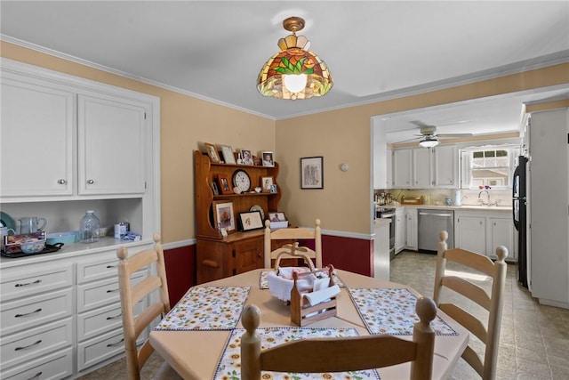 dining room with ceiling fan and ornamental molding