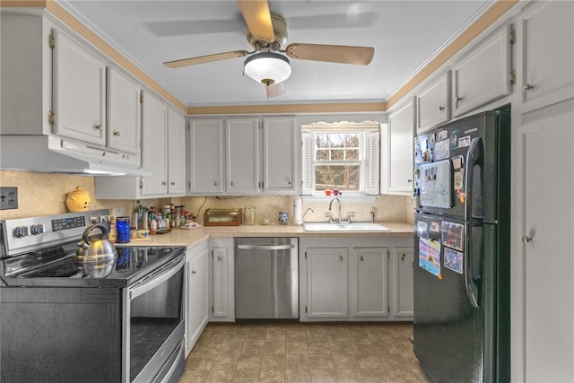 kitchen featuring a sink, decorative backsplash, light countertops, stainless steel appliances, and under cabinet range hood