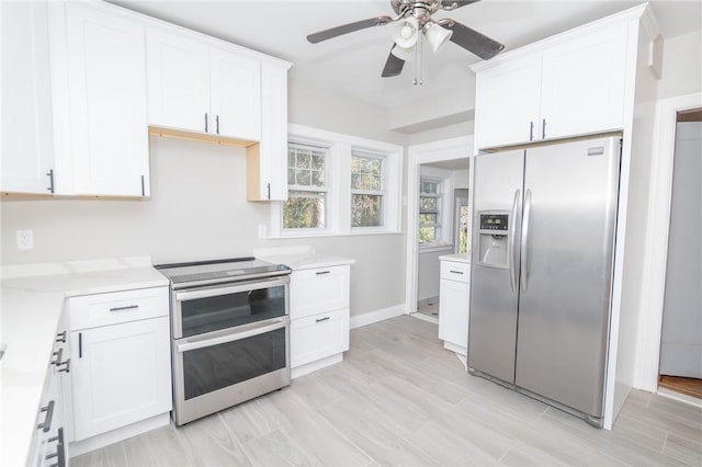 kitchen featuring white cabinetry, light countertops, a ceiling fan, and appliances with stainless steel finishes