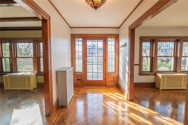 doorway to outside featuring baseboards and ornamental molding