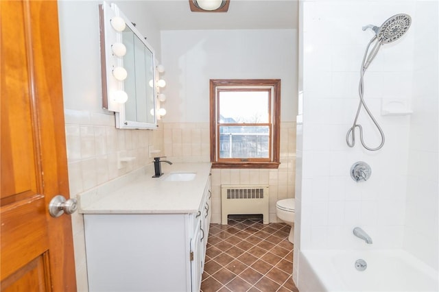 bathroom featuring toilet, radiator, tile walls, tile patterned flooring, and vanity