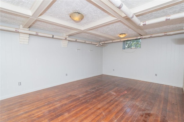 basement featuring a textured ceiling and wood-type flooring