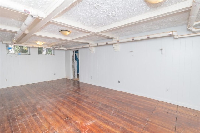 basement with a textured ceiling and hardwood / wood-style floors