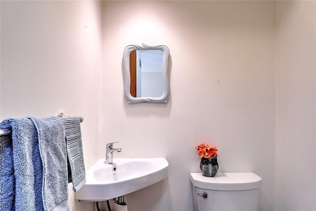 bathroom with toilet and a sink