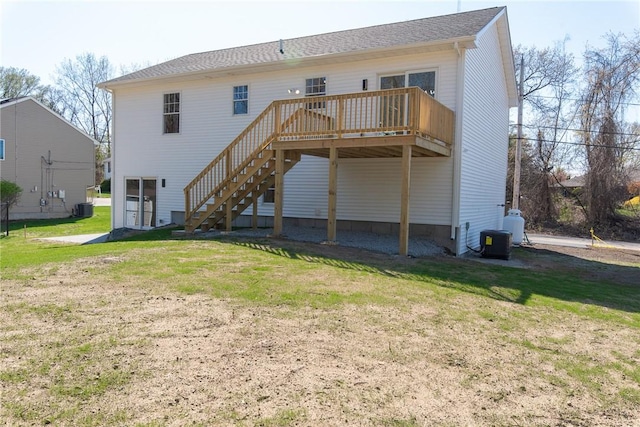 rear view of house with a lawn, stairway, central air condition unit, and a wooden deck