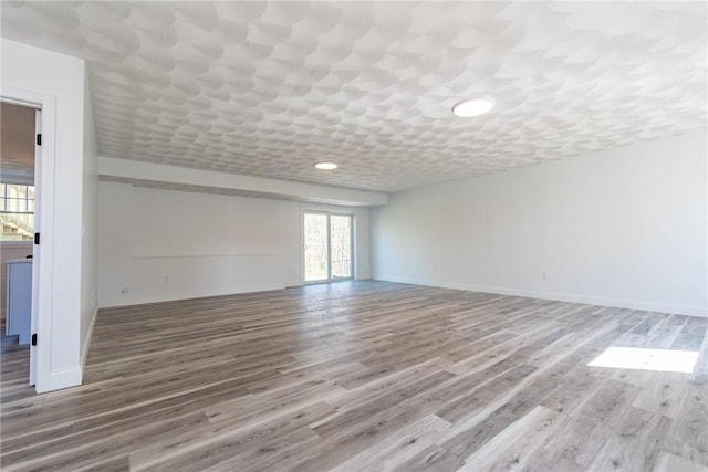 unfurnished room featuring wood finished floors and baseboards