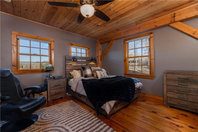 bedroom with multiple windows, wooden ceiling, and hardwood / wood-style flooring