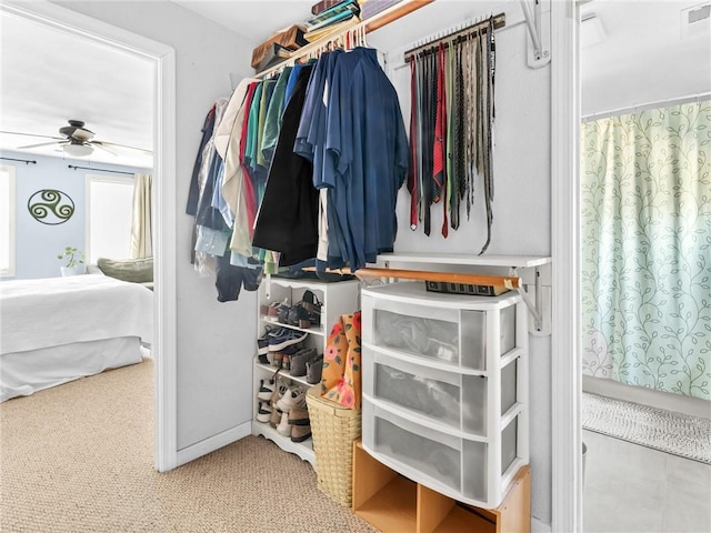 walk in closet featuring visible vents and a ceiling fan