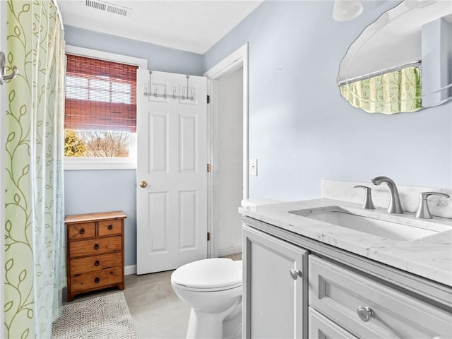 full bathroom with vanity, tile patterned floors, toilet, and visible vents